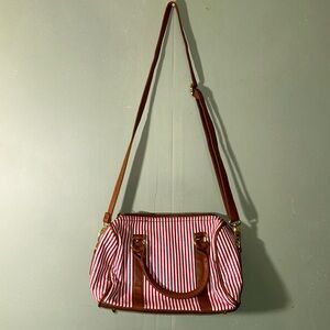 Charming Charlie red and white cross body purse with tan and gold accents